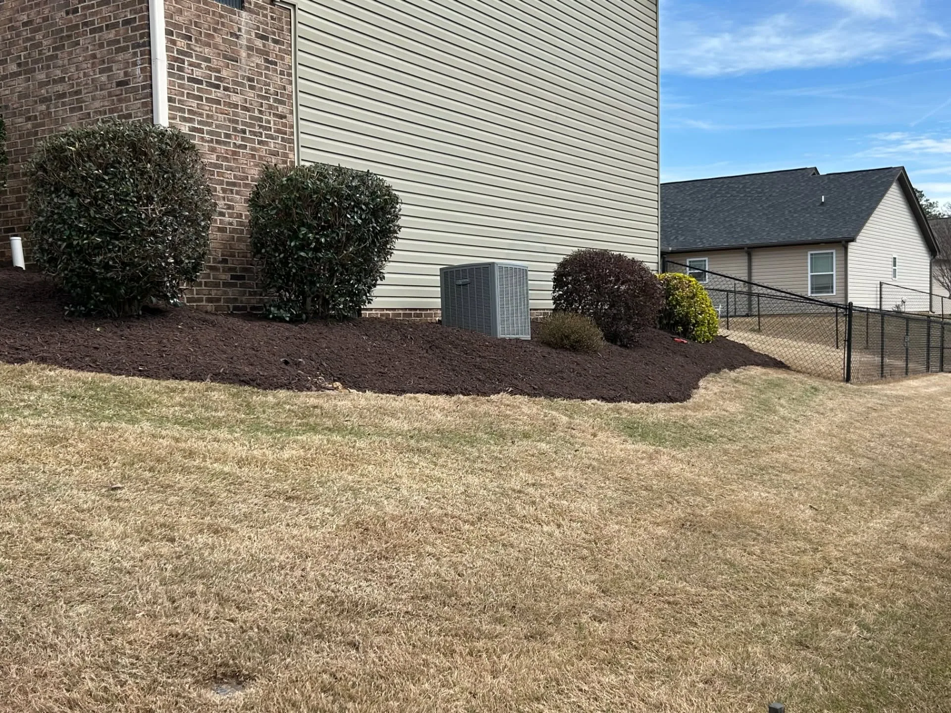 Ac unit mulch bed rounded shrubs upstate SC