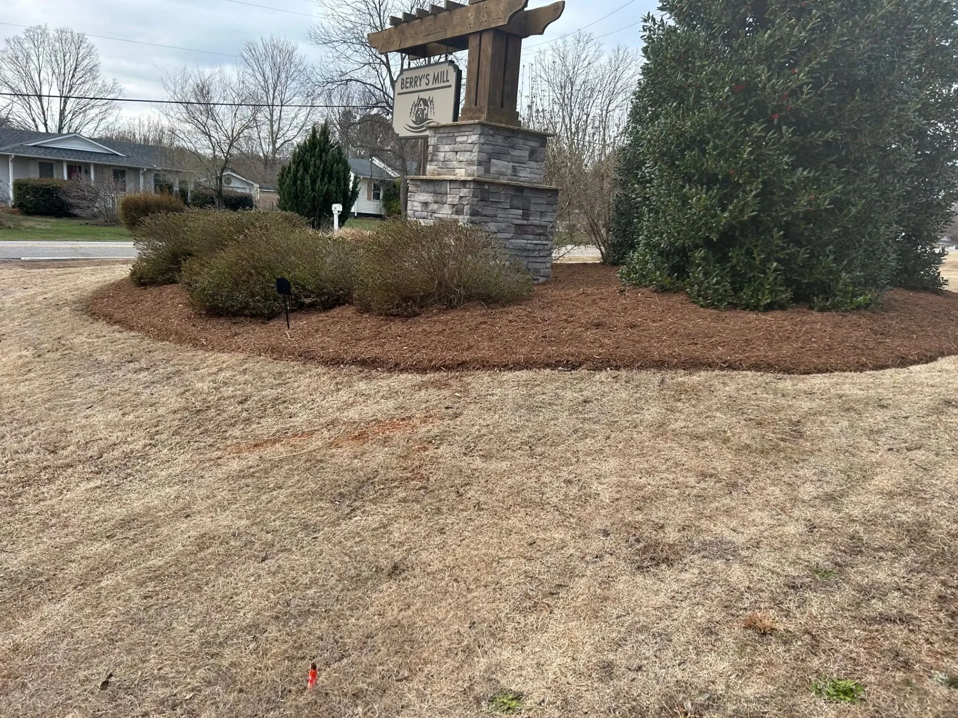 Berrys mill entrance sign mulch bed holly