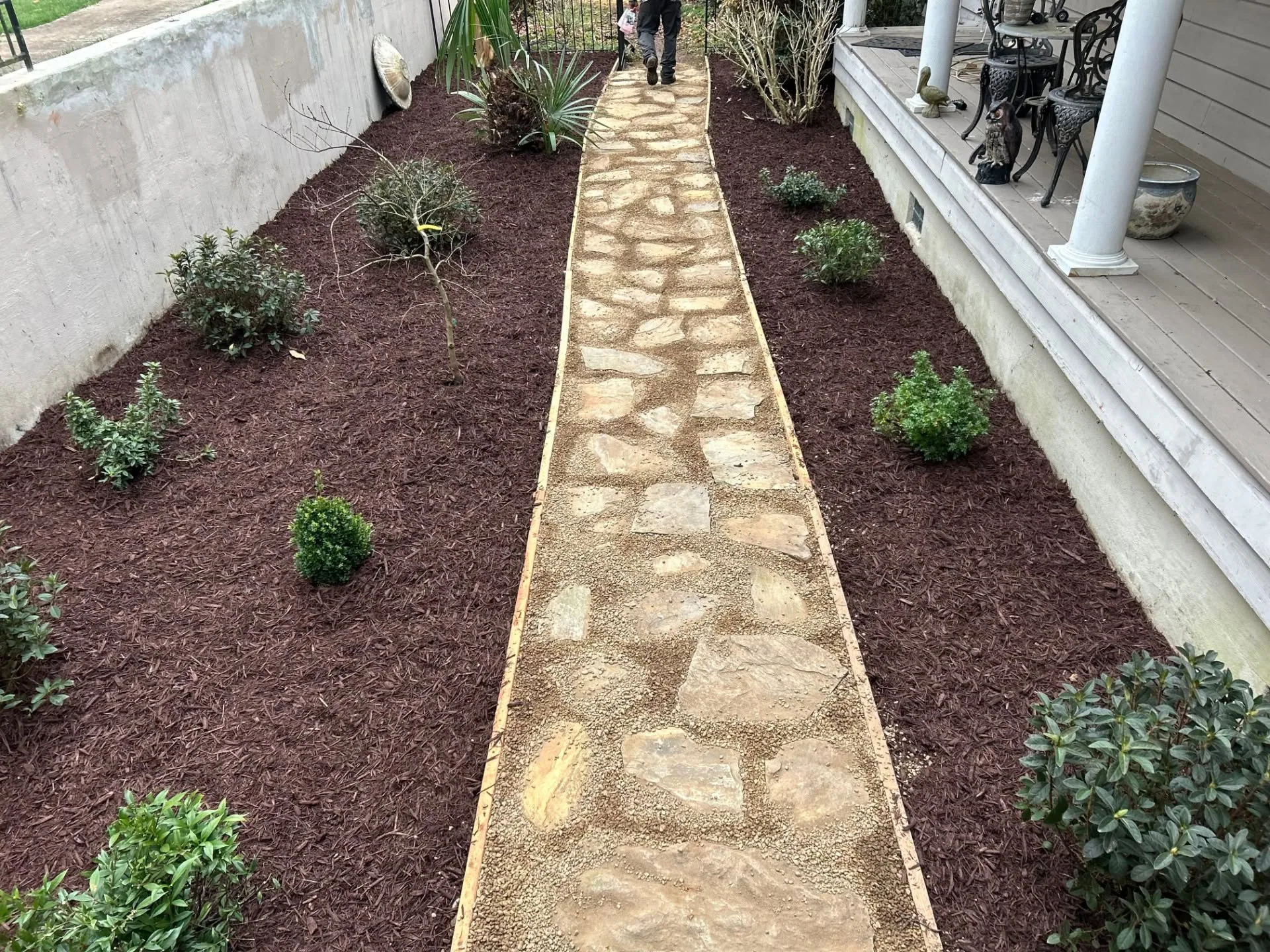 Flagstone gravel side yard path brown mulch beds