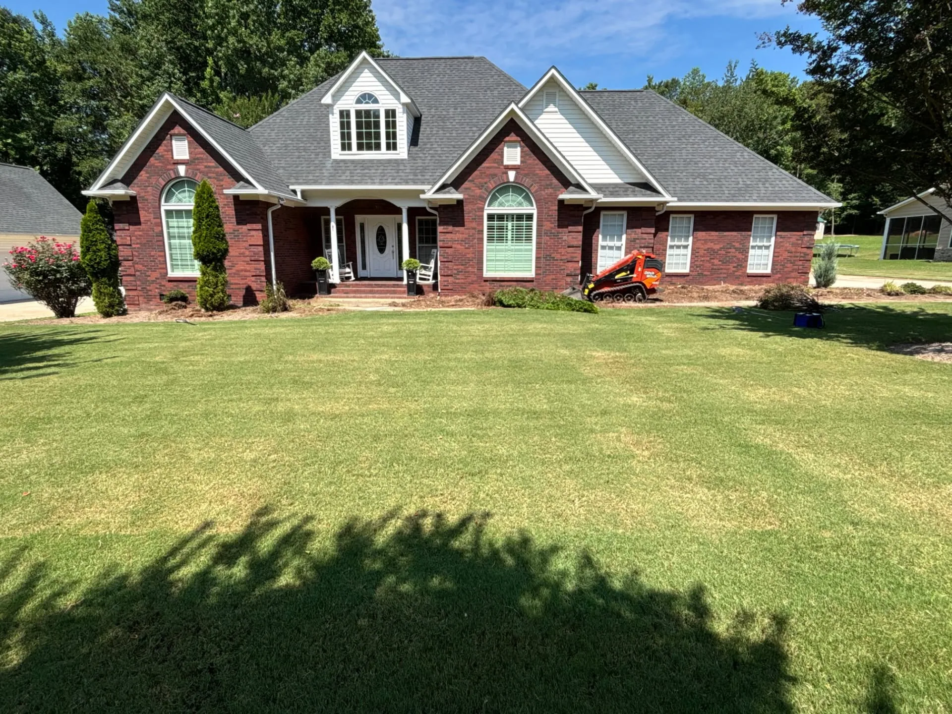 Mini track loader wide front lawn brick home upstate SC
