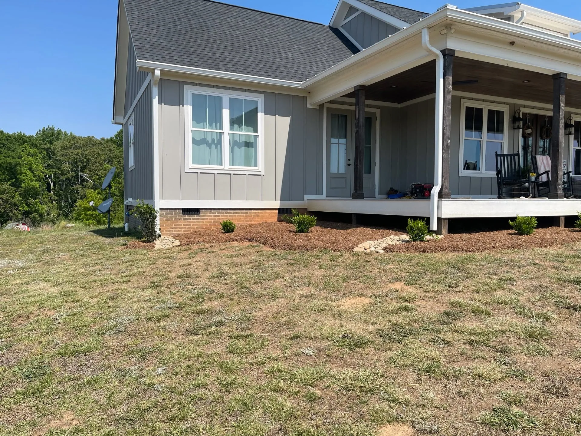 New mulch bed young shrubs farmhouse porch upstate sc.e9bfc3f0