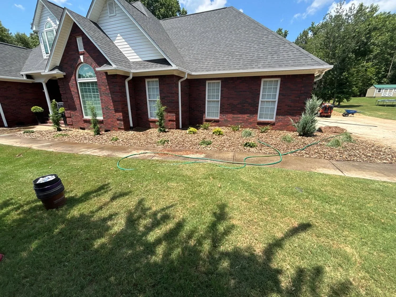 New river rock foundation planting red brick home.179fd1ad