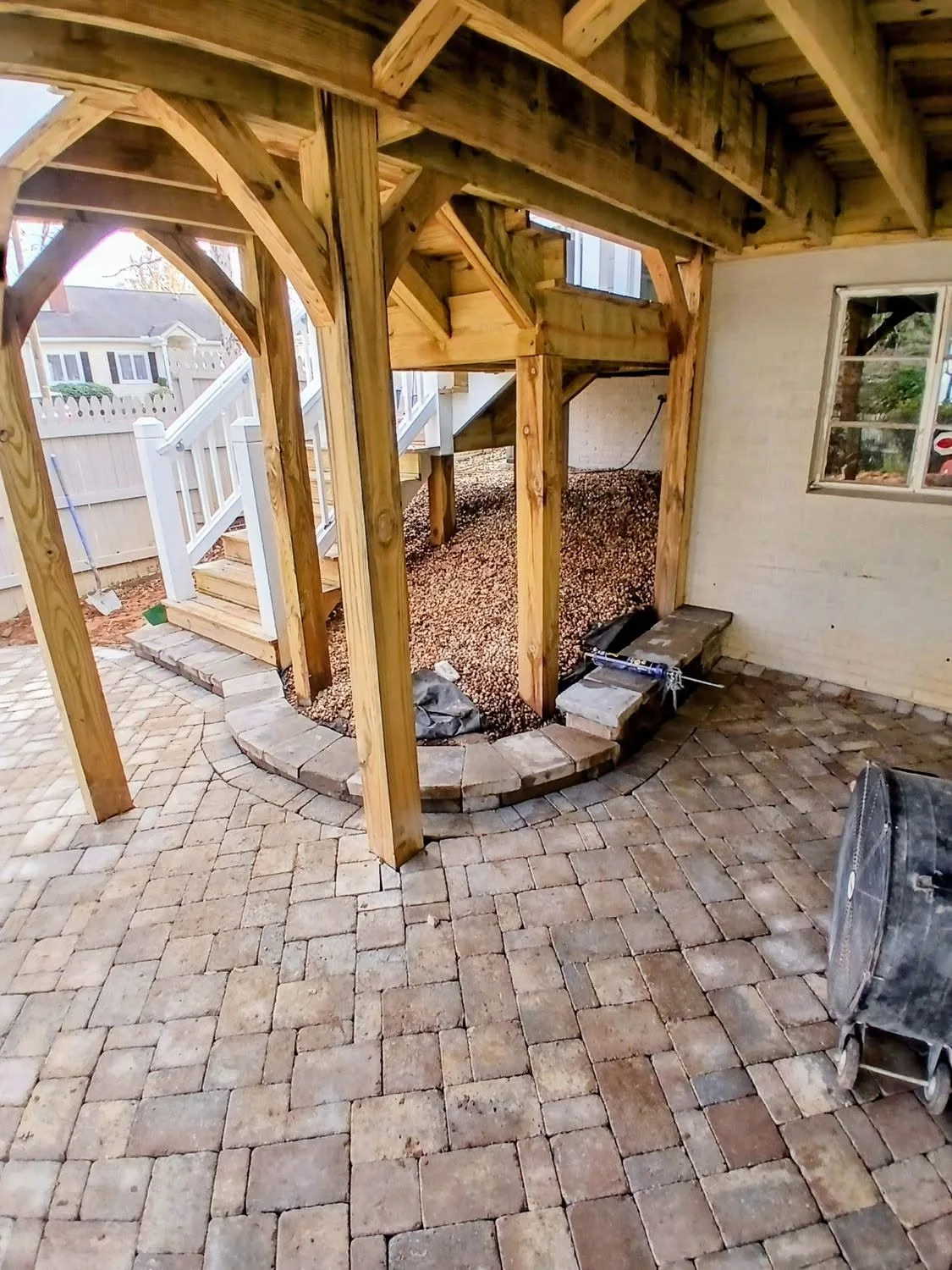 Under deck paver patio curved gravel bed